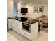 Spacious kitchen with a large island, white cabinetry, stainless steel microwave, and adjoining living area at 125 5Th Ne Ave # 240, St Petersburg, FL 33701