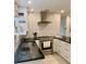 Well-equipped kitchen featuring stainless steel appliances, white cabinets, and subway tile backsplash at 125 5Th Ne Ave # 240, St Petersburg, FL 33701