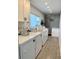 Clean and spacious laundry room with multiple white washers and dryers, cabinets, and wood floors at 125 5Th Ne Ave # 240, St Petersburg, FL 33701
