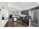 Stylish kitchen featuring stainless appliances, modern cabinetry, and an open layout connecting to the dining area at 13411 Beechberry Dr, Riverview, FL 33579