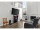 This living room has a fireplace, a large TV, and modern furnishings at 13411 Beechberry Dr, Riverview, FL 33579