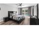 Bedroom featuring wood floors, a ceiling fan, and sliding glass doors that lead to the pool at 13411 Beechberry Dr, Riverview, FL 33579