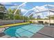 Large screened in pool with chairs and grill on the pool deck for entertaining and relaxation at 13411 Beechberry Dr, Riverview, FL 33579