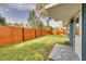 Fenced backyard with lush lawn and access to the house at 1466 Laconia W Dr, Clearwater, FL 33764