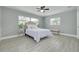 Bedroom featuring wood-look tile floors, two windows, and neutral paint at 1466 Laconia W Dr, Clearwater, FL 33764