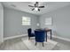 Cozy bedroom featuring wood-look tile floors, ceiling fan, and desk area at 1466 Laconia W Dr, Clearwater, FL 33764