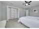 Bedroom featuring wood-look tile floors, ceiling fan, and a large closet at 1466 Laconia W Dr, Clearwater, FL 33764