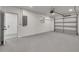 Spacious garage featuring epoxy flooring and automatic door at 1466 Laconia W Dr, Clearwater, FL 33764