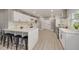 Modern kitchen featuring white cabinets, stainless steel appliances, a waterfall countertop island, and tile flooring at 1466 Laconia W Dr, Clearwater, FL 33764