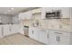 Bright kitchen features white cabinets, stainless steel appliances, and stylish countertops at 1466 Laconia W Dr, Clearwater, FL 33764