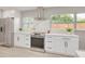 Updated kitchen with stainless steel appliances and marble backsplash at 1466 Laconia W Dr, Clearwater, FL 33764