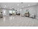 Spacious living room featuring tile floors, recessed lighting, comfortable seating, and ample natural light from the window at 1466 Laconia W Dr, Clearwater, FL 33764