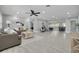 Spacious living room featuring tile floors, a ceiling fan, recessed lighting, and contemporary furnishings and decor at 1466 Laconia W Dr, Clearwater, FL 33764
