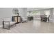 Open-concept living room and dining area with tile floors, neutral paint colors, and stylish furnishings and decor at 1466 Laconia W Dr, Clearwater, FL 33764