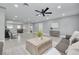 Large open living room featuring tile floors, recessed lights, contemporary furniture, and an open layout to the kitchen at 1466 Laconia W Dr, Clearwater, FL 33764