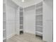 Walk-in closet with custom shelving and ample storage at 1466 Laconia W Dr, Clearwater, FL 33764