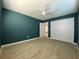 A clean, finished bedroom with wood-look floors, dark walls, ceiling fan and ample closet space at 2198 Wateroak N Dr, Clearwater, FL 33764