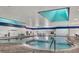 Indoor pool featuring a bright interior with skylights, comfortable seating, and easy water access at 2202 Clubhouse Dr # 177, Sun City Center, FL 33573