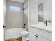 Cozy bathroom with tub and shower combination, white vanity, and tile flooring at 2472 Orange Harvest Pl, Seffner, FL 33584