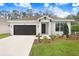 Charming single-story home with dark garage door and well-manicured lawn at 2472 Orange Harvest Pl, Seffner, FL 33584