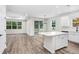 Open floor plan kitchen with bright white cabinets and island with white countertops at 2472 Orange Harvest Pl, Seffner, FL 33584