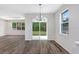 Bright living room with hardwood floors, recessed lighting and large sliding glass doors to backyard at 2472 Orange Harvest Pl, Seffner, FL 33584