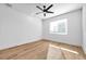 Bright bedroom featuring wood floors, a ceiling fan, and a window with natural light at 2608 W Columbus Dr # 2, Tampa, FL 33607