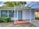 Exterior of home with a light-blue front door, garage, and pathway leading up to the home at 280 Twin Lake Dr, Largo, FL 33770