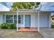 Home with a light-blue front door, garage, and pathway leading up to the home at 280 Twin Lake Dr, Largo, FL 33770