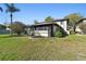 Inviting home exterior with a well-maintained lawn, lush bushes, and a screened-in lanai at 2933 Lichen Ln # A, Clearwater, FL 33760