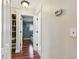 Hallway features hardwood floors, white trim and doors, and a built-in shelving unit for storage at 2933 Lichen Ln # A, Clearwater, FL 33760