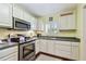 This kitchen features stainless steel appliances, and light yellow wall color at 2933 Lichen Ln # A, Clearwater, FL 33760