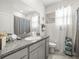 Well-lit bathroom with granite countertop, large mirror, and modern fixtures at 31465 Mango Fade Way, San Antonio, FL 33576