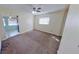 Cozy bedroom with soft carpeting, a ceiling fan, and natural light from a window at 3165 58Th N Way, St Petersburg, FL 33710