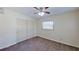 This carpeted bedroom features a ceiling fan, window, and closet with sliding doors at 3165 58Th N Way, St Petersburg, FL 33710