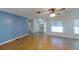 Bright living room featuring a ceiling fan, tile and wood-look flooring, and natural light from the windows at 3165 58Th N Way, St Petersburg, FL 33710