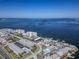 Coastal community aerial view showcasing bay views, boat docks, and beachfront living at its finest at 340 Causeway Blvd # 108, Dunedin, FL 34698
