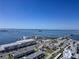 Expansive aerial view showcasing a coastal city, bright blue bay waters, and clear blue skies at 340 Causeway Blvd # 108, Dunedin, FL 34698