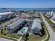Overhead shot of a complex featuring a pool, landscaping, parking and proximity to the Gulf of Mexico at 340 Causeway Blvd # 108, Dunedin, FL 34698