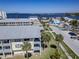 Scenic aerial view of waterfront condos, palm-lined streets, and beautiful bay waters at 340 Causeway Blvd # 108, Dunedin, FL 34698