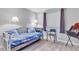 Bright bedroom features natural light from the window, wood floor, and two sconce lights at 340 Causeway Blvd # 108, Dunedin, FL 34698