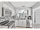 Open-concept kitchen boasting stainless steel appliances, granite countertops, and view to the living area at 340 Causeway Blvd # 108, Dunedin, FL 34698