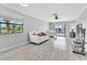 Inviting living room with tile floors, ample light, with neutral colors and a ceiling fan at 340 Causeway Blvd # 108, Dunedin, FL 34698