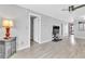 Bright and airy living room featuring neutral paint colors, modern ceiling fan, and wood-look flooring at 340 Causeway Blvd # 108, Dunedin, FL 34698
