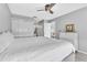 Calming main bedroom with a ceiling fan and white bedding with a view to living room at 340 Causeway Blvd # 108, Dunedin, FL 34698