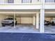 Covered parking area showcasing multiple vehicles, providing sheltered spots for residents and guests at 340 Causeway Blvd # 108, Dunedin, FL 34698