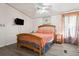 Bedroom featuring a comfortable queen size bed and mounted TV at 3921 Chris Dr, Wesley Chapel, FL 33543
