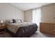 Bedroom featuring a comfortable queen size bed and woodgrain dresser at 3921 Chris Dr, Wesley Chapel, FL 33543