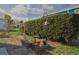 Outdoor space featuring a birdhouse, bird bath, and a manicured hedge in the yard at 3921 Chris Dr, Wesley Chapel, FL 33543