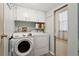 Laundry room featuring a washer and dryer with overhead cabinetry at 3921 Chris Dr, Wesley Chapel, FL 33543